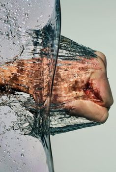 a person's hand holding an object with water on it and the image is split in half