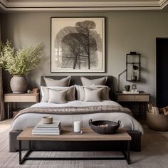 a large bed sitting in a bedroom on top of a hard wood floor next to a table