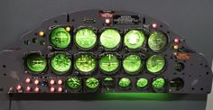 an airplane cockpit with many green lights on it's display panel and control buttons