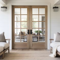 a living room filled with furniture and two doors