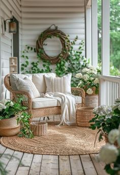 the porch is decorated with wicker furniture and flowers