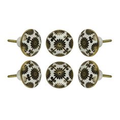 four black and white knobs with gold accents