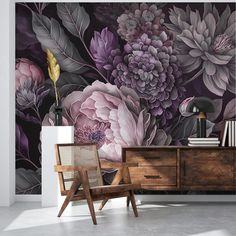 a room with flowers on the wall and a chair in front of it, next to a dresser