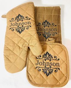 two oven mitts with personalized labels on them, one is tan and the other is brown