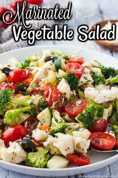 a white bowl filled with pasta and veggies on top of a wooden table