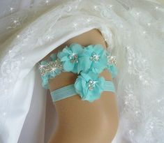 Keepsake Garter, Aqua Blue Wedding Garter Set, Heirloom Wedding Garter Belts, Bridal Garter, Garters, Rhinestone Garter, Wedding Garder Exquisite AQUA BLUE satin garter with organza frill edge is adorned with 2 soft aqua blue chiffon flowers. The flowers have pearls and sparkling rhinestones in the center. A rhinestone beaded trim enhances the sides of the main garter. The sparkling effect is breathtaking, especially when the light hits it The toss garter is aqua blue satin and stretch satin elastic with a matching chiffon flower.  This garter set is made to order. Also available in white, ivory, black or pink. Other colors upon request as a custom order.  PLEASE NOTE YOUR WEDDING DATE AND THE ACTUAL MEASUREMENT OF YOUR THIGH WHERE YOU WILL BE WEARING THE GARTER. If a date is not included Cheap Light Blue Dresses With Lace Trim, Cheap Non-stretch Light Blue Dresses, Wedding Garders, Wedding Garder, Girly Wedding, Crystal Garter, Aqua Blue Wedding, Rhinestone Garter, Wedding Garter Blue