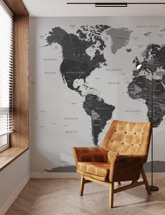 a chair sitting in front of a wall with a map on it