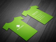 two green business cards sitting on top of a wooden table, with the words blookies