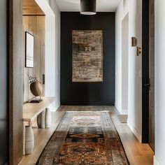 a long hallway with a rug on the floor and an area rug on the wall