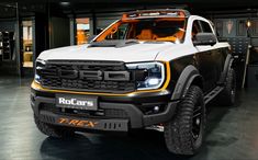 a white and black truck parked in a garage