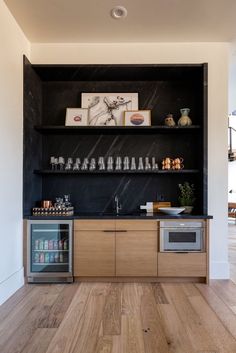 a kitchen with wooden floors and black walls