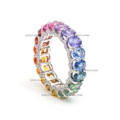 Rainbow sapphire ring with diamond accents | Natural rainbow sapphire oval cut eternity band | Rainbow sapphire eternity band ring in gold STONE DETAILS : ✦ Stone : Rainbow Sapphire ✦ Stone Type : Natural ✦  Ring Width : 7.20 mm ✦ Ring Height : 3.50 mm ✦ Stone Size : 5x4mm ✦ Stone Shape : Oval cut ✦ Number of stones : 17 ✦ Stone Weight : 7-8 carats ✦ Stone Grade : AAA DIAMOND DETAILS : ✦ Diamond Type : Natural ✦ Diamond Size : 1.20 mm ✦ Diamond Shape : Round cut ✦ Number of diamonds : 100 ✦ Diamond Weight : 0.70 carat METAL DETAILS : ✦ Metal : Solid 14K / 18K Gold ✦ Metal Color : Yellow / White / Rose Gold ✦ Setting : Prong Setting ✦ Ring Box : Yes SHIPPING DETAILS : ✦ Shipped via : UPS ✦ Production time : 10-12 days ✦ Delivery time : 7-8 days ✦ Expedited shipping : Available ✦ Expedited s Rainbow Sapphire Ring, Sapphire Eternity Band, Rainbow Ring, Rainbow Sapphires, Rainbow Rings, Fairy Wedding, Multi Sapphire, Nature Ring, Rainbow Bracelet