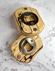 two wooden objects sitting on top of a marble counter