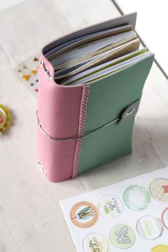 a pink and green binder sitting on top of a table