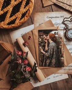 an assortment of old fashioned postcards and other items on top of a wooden table