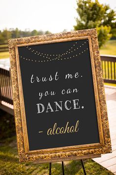 a sign that says trust me you can dance alcohol on the side of a bench