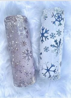 two snowflakes are sitting next to each other on a white fur covered surface