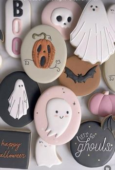 there are many decorated cookies in the box with ghostes and bats on each one