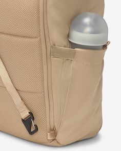 an open backpack with a bottle in the back pocket and a strap around the bottom