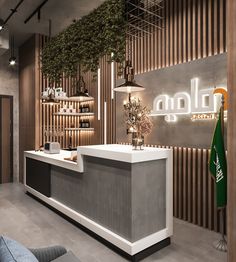 the front desk of an office with plants growing on it's walls and shelves