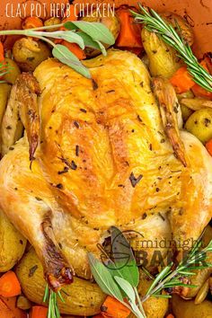 a roasted chicken with carrots, potatoes and herbs in a roasting pan for thanksgiving dinner