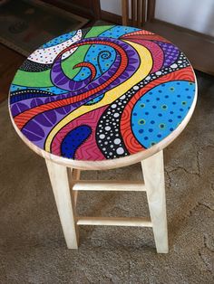 a stool with an artistic design painted on it