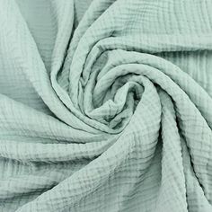 a close up shot of a light green fabric