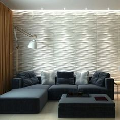 a living room filled with furniture next to a wall covered in wavy papered walls