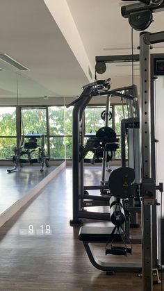 an empty gym room with mirrors and exercise equipment