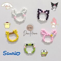 six pairs of beaded bracelets are displayed on a white surface with the words sanrio written below them