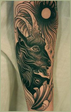 a black and white tattoo with an animal on it's leg