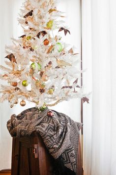 a white christmas tree with ornaments on it