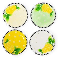 four plates with lemons and leaves painted on them