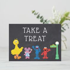 a chalkboard with sesame street characters painted on it