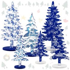 three blue and white christmas trees with snowflakes on them, all in different sizes