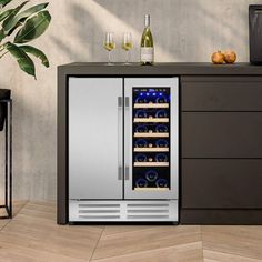 an image of a wine cooler in the middle of a room with bottles and glasses on it