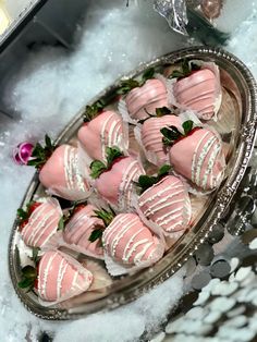 a platter filled with pink and white chocolate covered strawberries