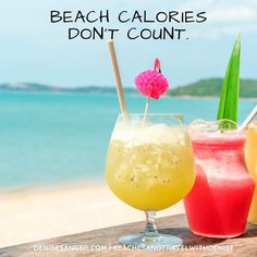 three drinks sitting on top of a wooden table next to the ocean with text that reads, beach calories don't count