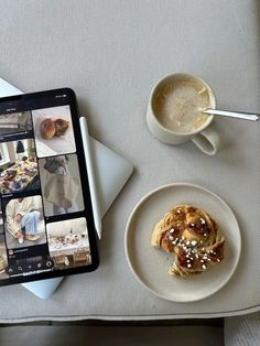 a table topped with a plate of food next to a cup of coffee and an ipad