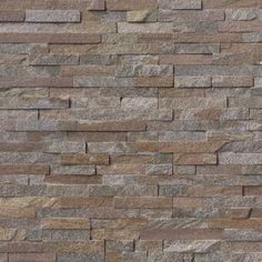 a stone wall with brown and gray bricks