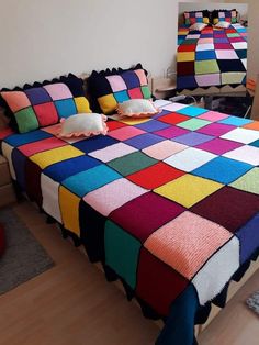 two beds covered in multicolored blankets with pillows on top of them and one bed made out of multiple colored squares