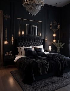 a black bedroom with chandelier and bed