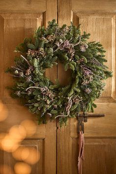 a wreath hanging on the front door of a house