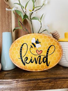 a wooden sign that says reind with a bee on it and flowers in the background