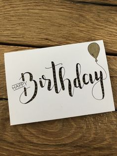 a card with the words happy birthday written in cursive writing and a balloon