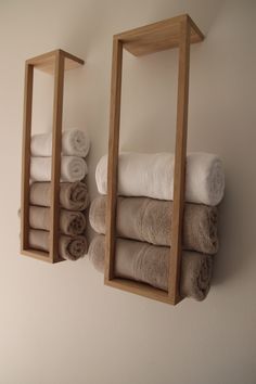 two wooden shelves holding towels and folded towels