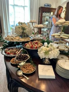 a table filled with lots of food and desserts