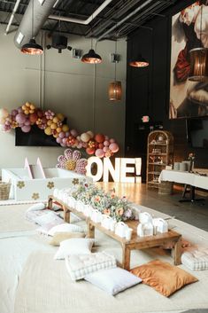 the table is set up with balloons and flowers on it, along with other decorations