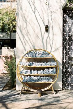 a rack with blue and white plates in front of a building