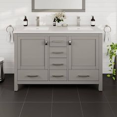 a bathroom vanity with two sinks and a mirror